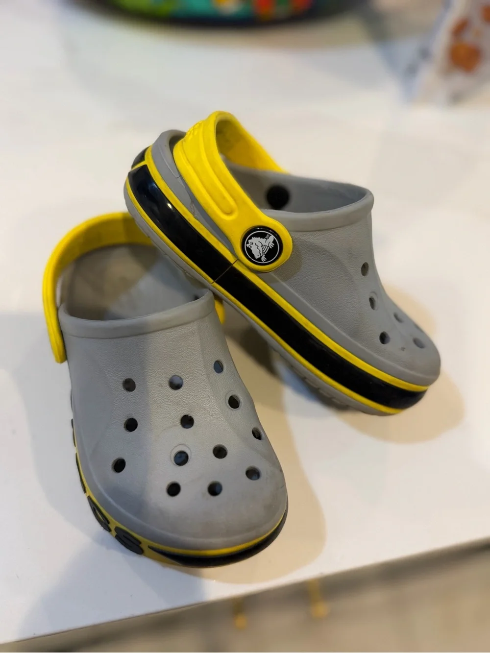 CROCS Kids Gray Clogs with Yellow Heel Strap